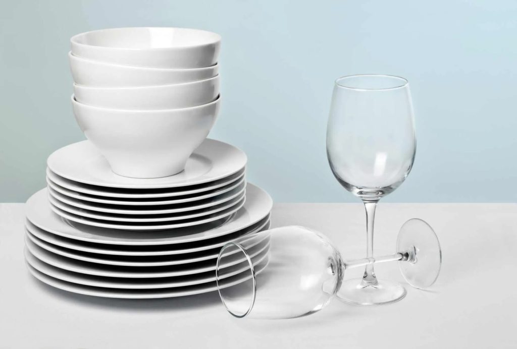 white bowl plates and two wine glasses