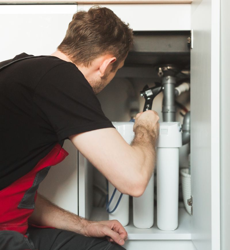 Plumber checking out water filtration system