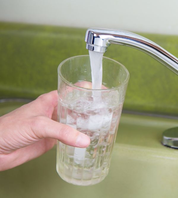 Person getting a glass of tap water
