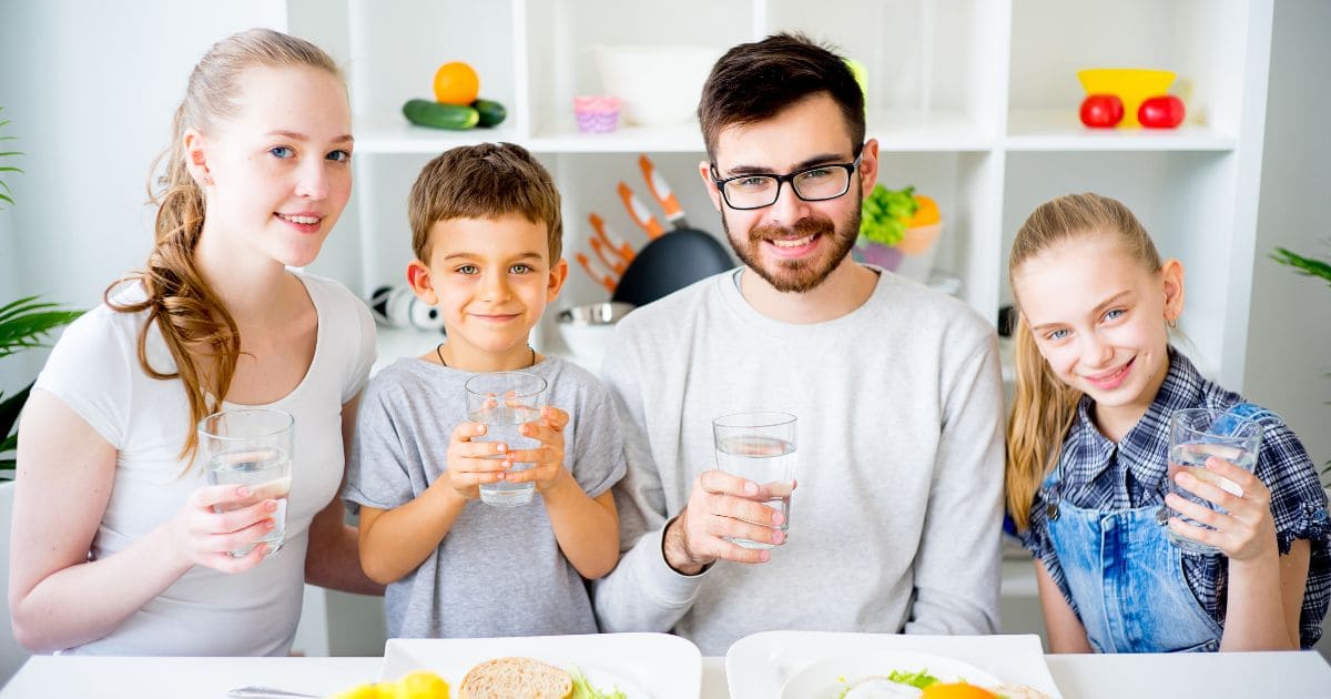 Family holding glasses of water