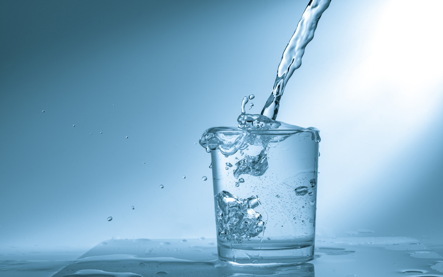 Drinking water is poured into a glass