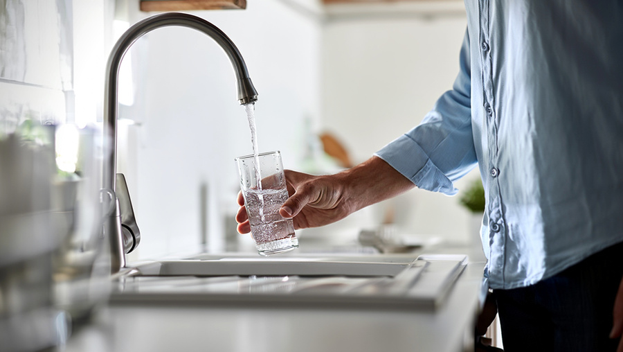 man filling treated filtered water from tap
