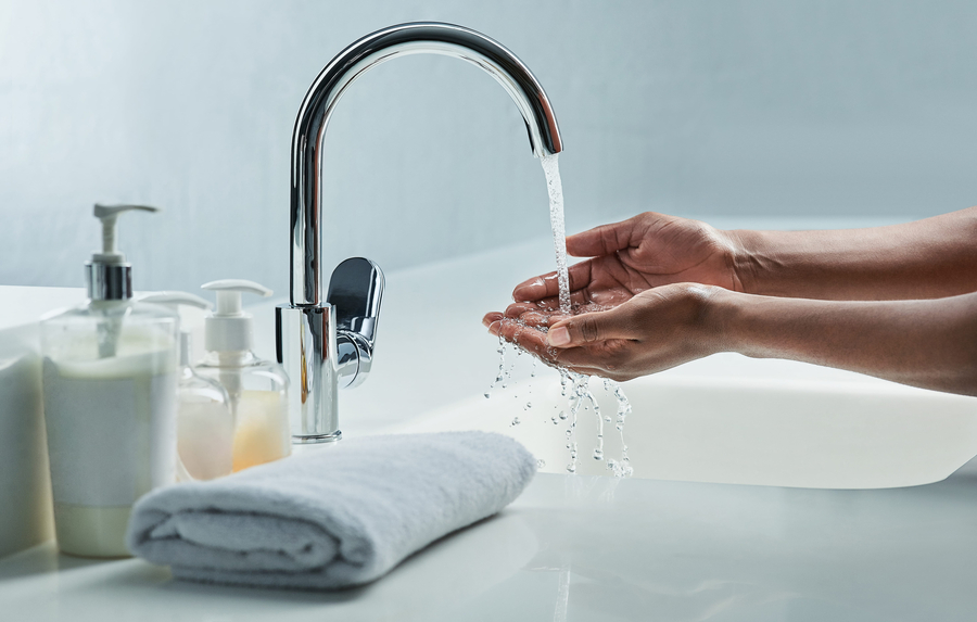 treated water from home's tap, woman handwashing